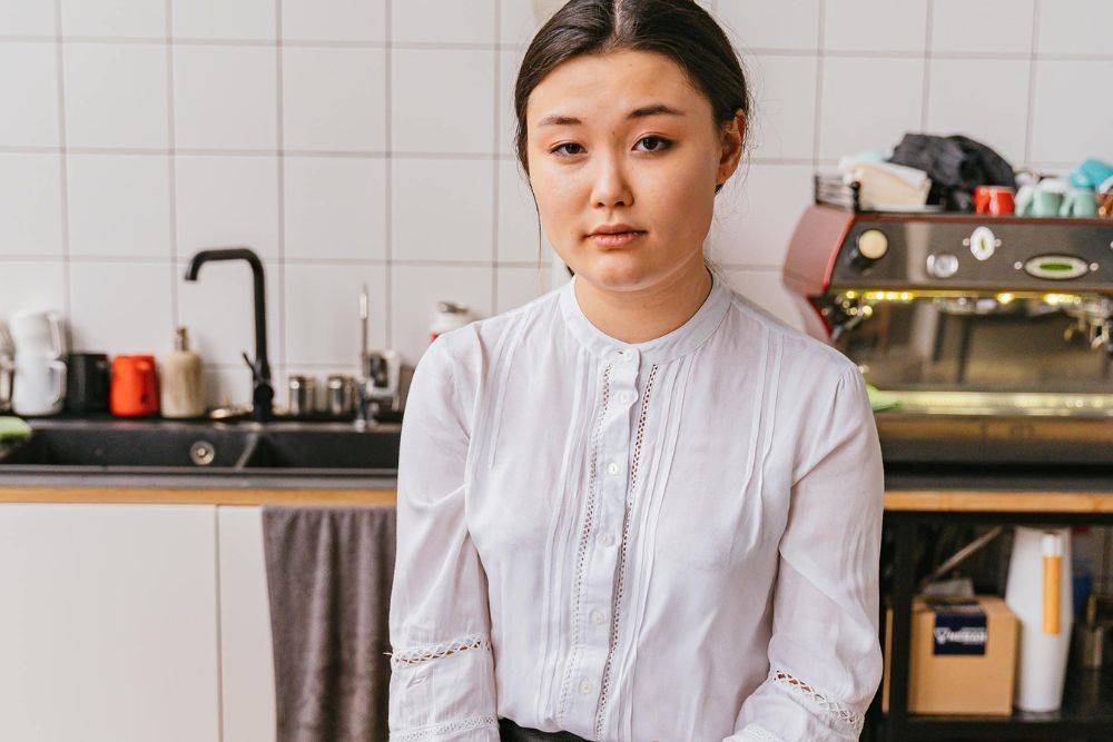 A young hospitality intern working inside a professional French kitchen